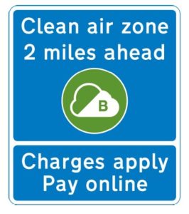 Road sign graphic indicating "Clean Air Zone 2 miles ahead - Charges Apply, Pay Online"