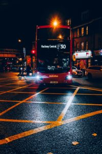 red and black double decker bus on road during night time