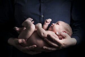 Close-Up Photo of a Person Carrying a Baby