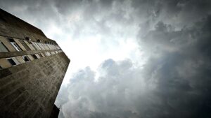 A tall building with a sky in the background