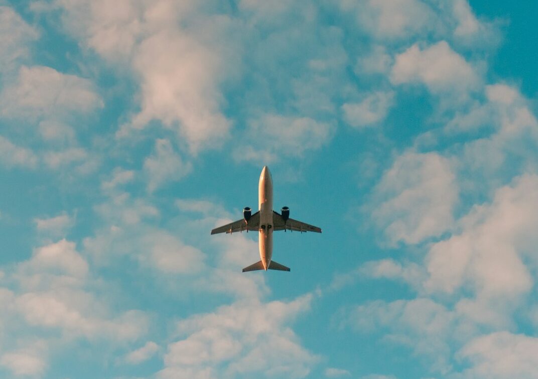 white airplane flying in the sky during daytime