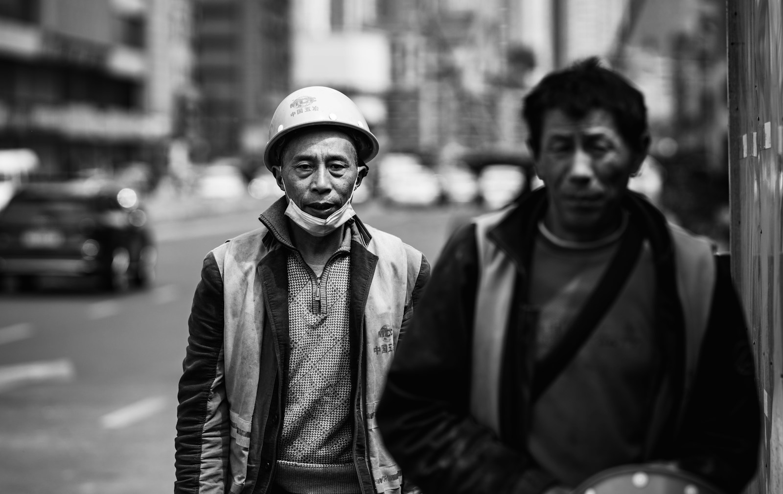 man in black jacket and white cap