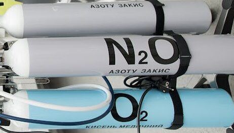 Bright dental clinic room featuring cutting-edge equipment and medical gas tanks for professional use.