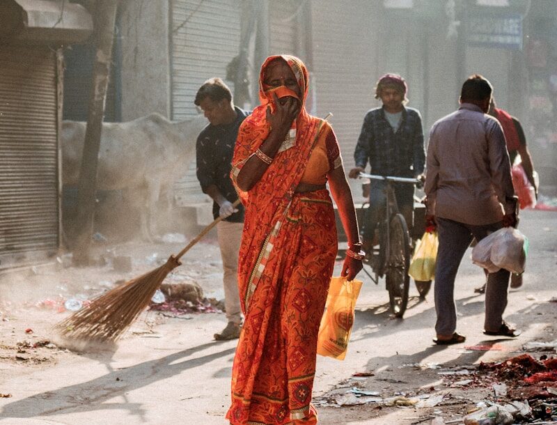 a woman walking down a street while talking on a cell phone