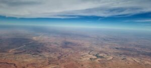 a large flat area with a body of water in the distance
